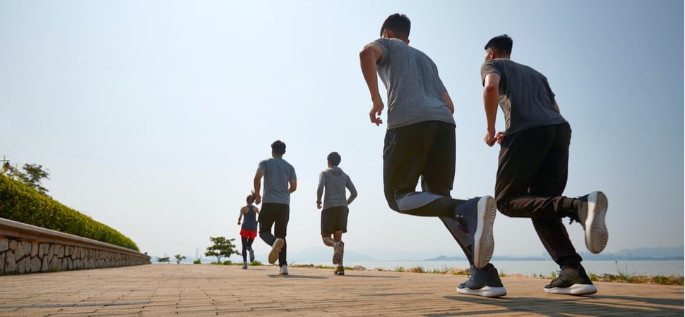 group of men and women running outdoors